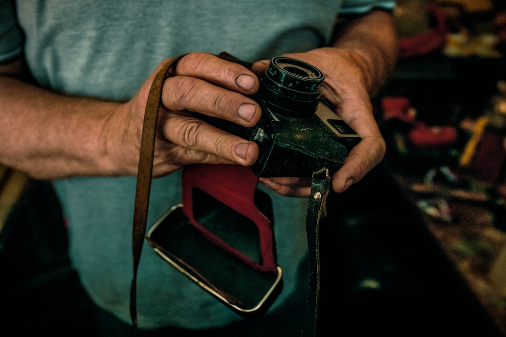 closeup photo of person holding camera