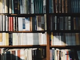 Shelf filled with various Lotus Press Books titles, bathed in warm natural light.