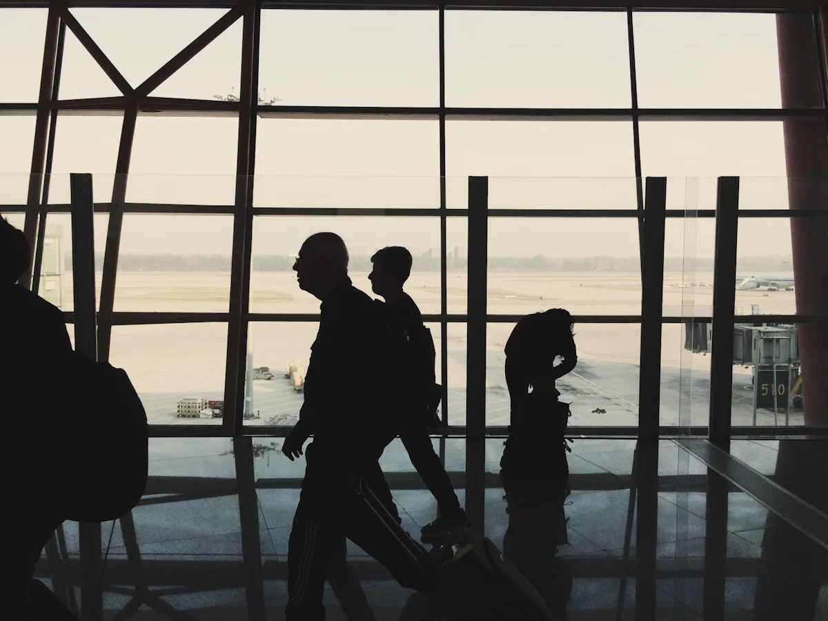 Travellers walking through an airport terminal