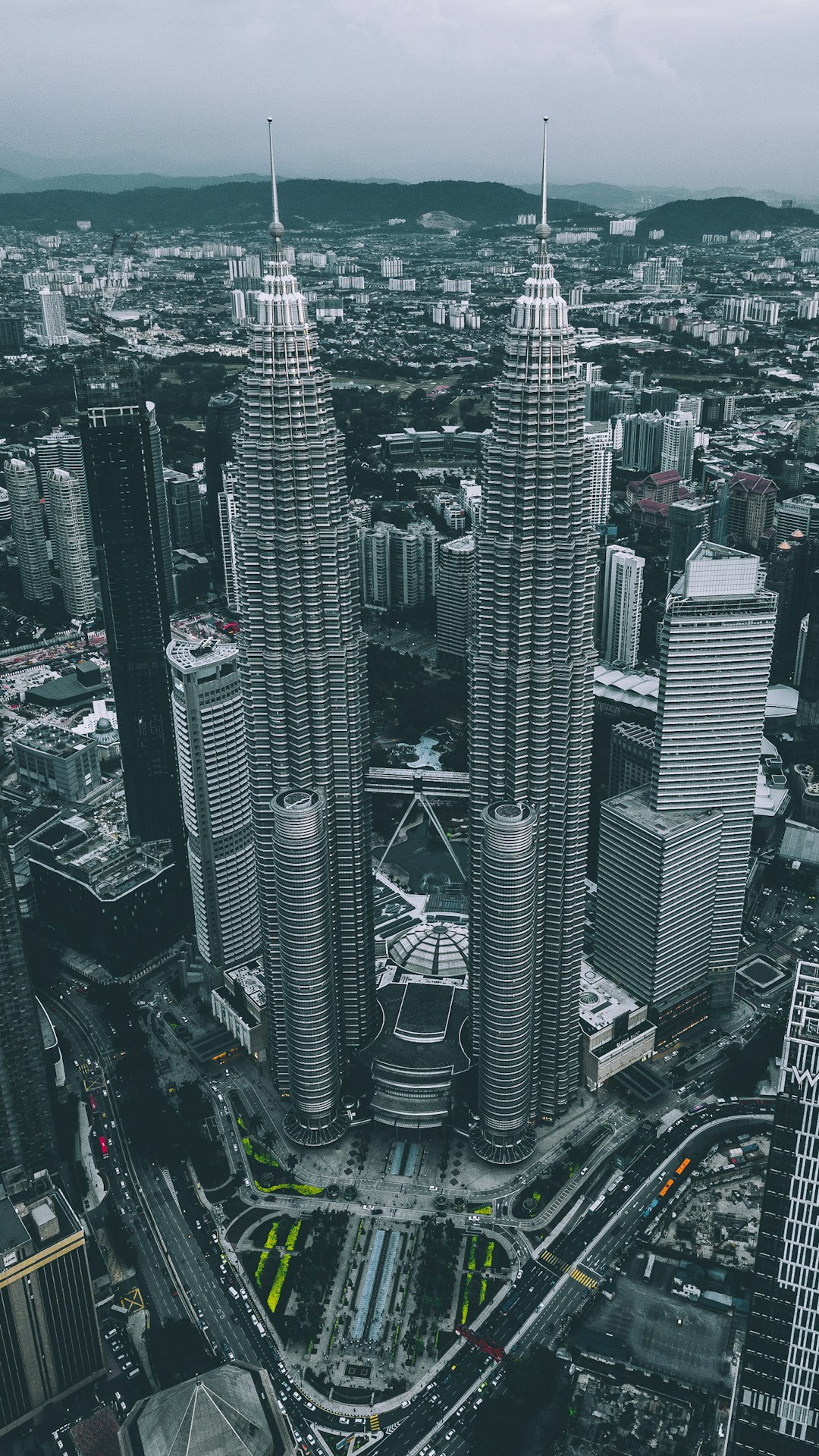 aerial view of gray twin tower concrete buildings under gray sky