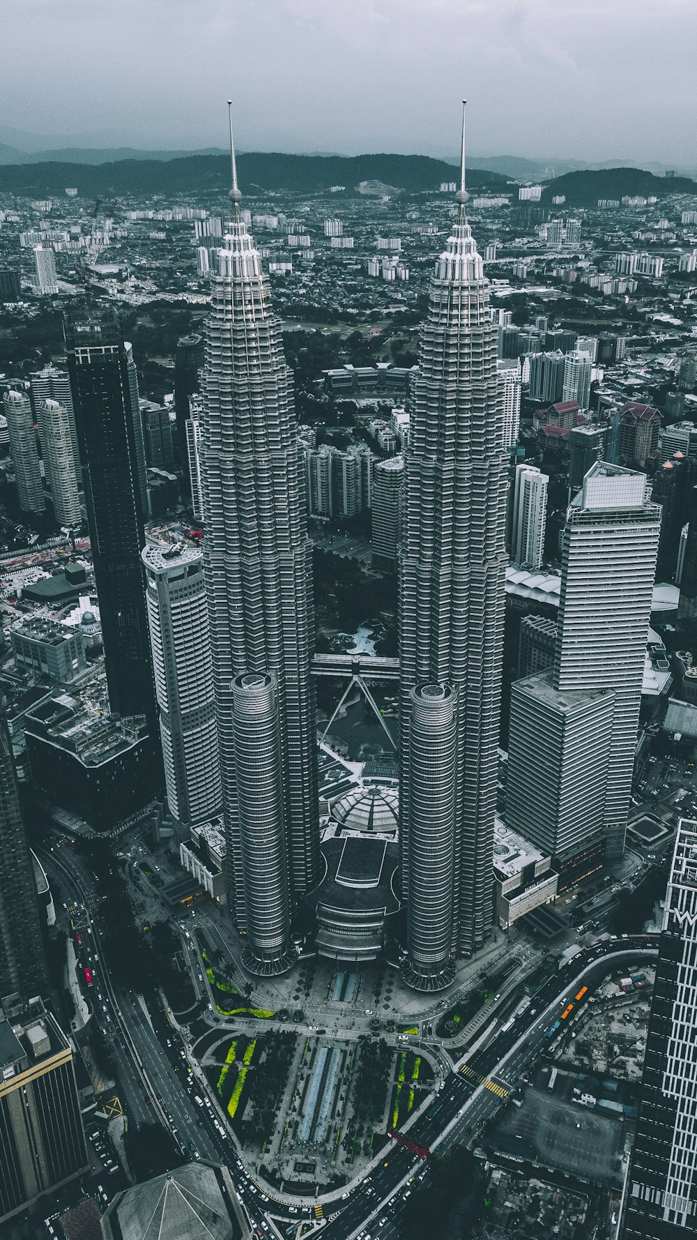 aerial view of gray twin tower concrete buildings under gray sky