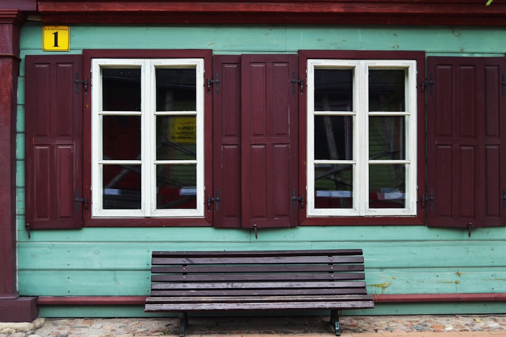 teal house with two windows