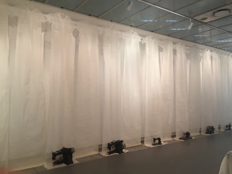 A close-up of vintage sewing machines lined up in the museum's cozy workspace.