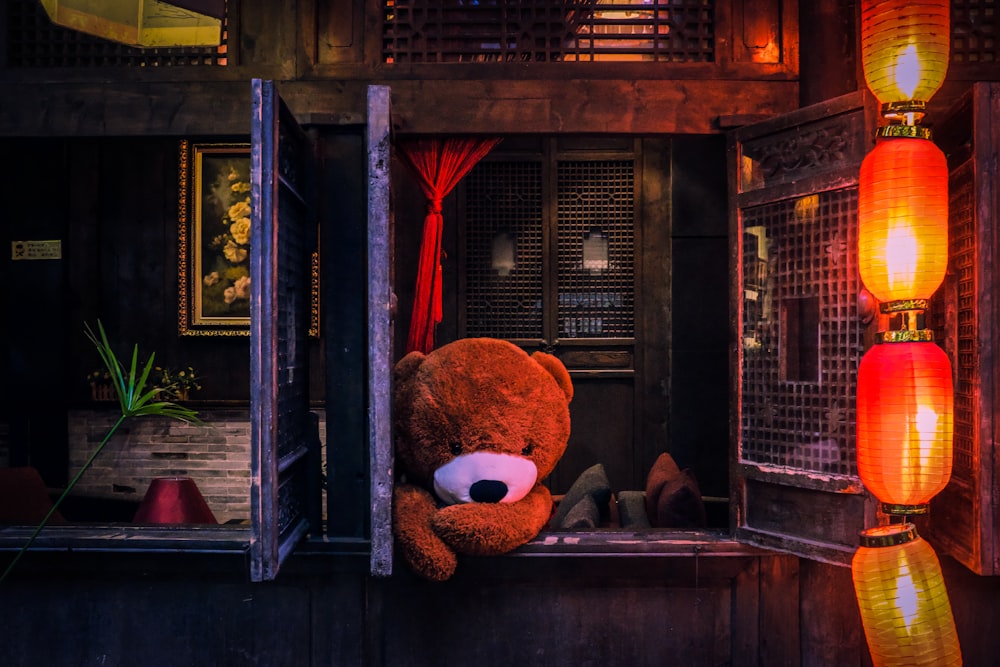 bear plush toy on window