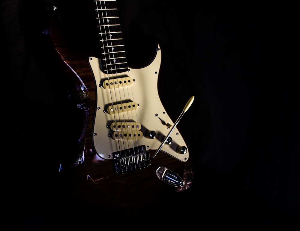 selective focus photography of white and red electric guitar