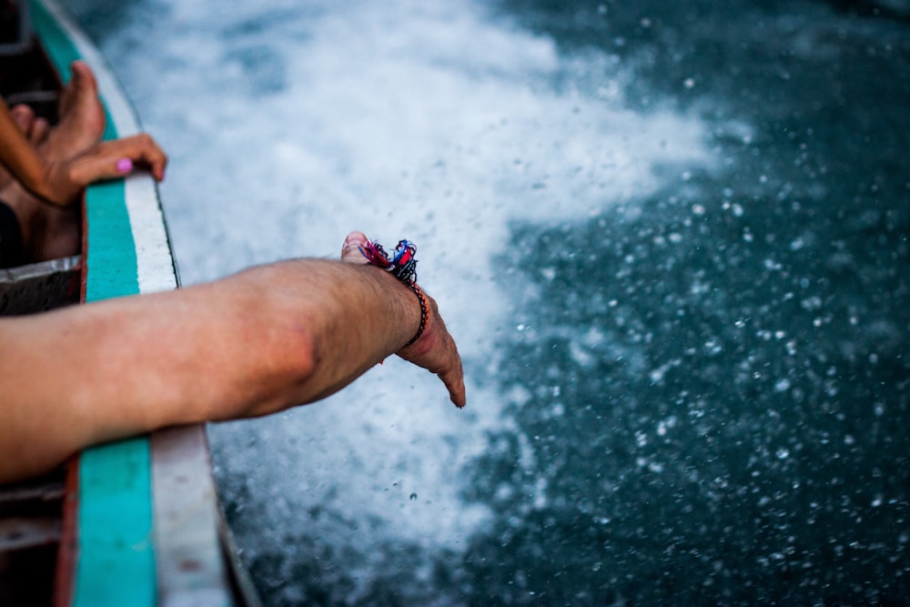 person's hand on sea