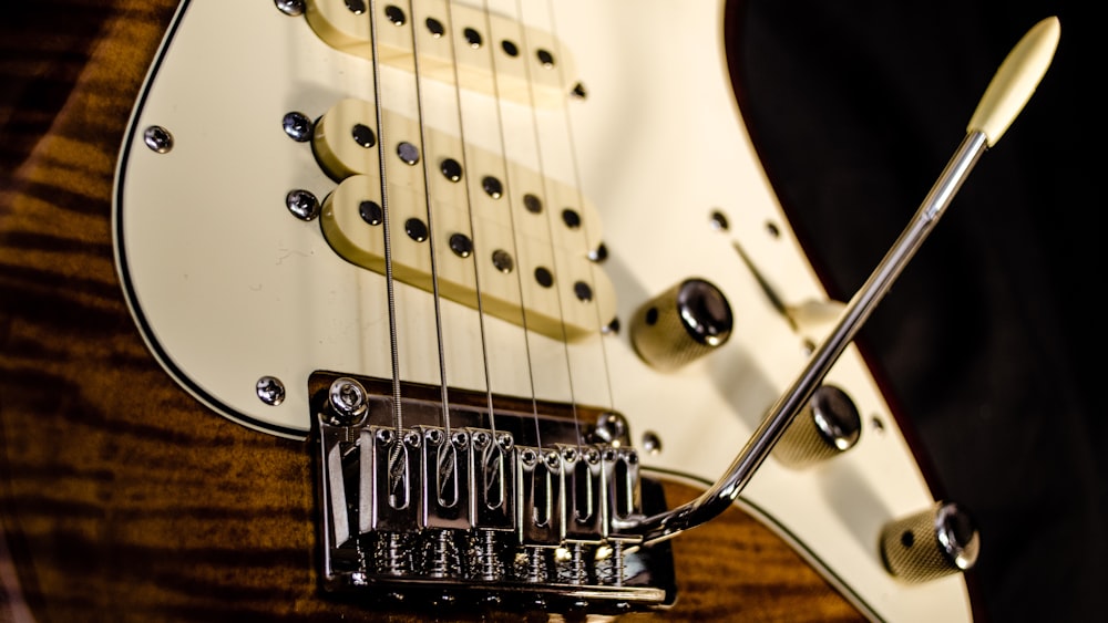 close up photography of brown electric guitar