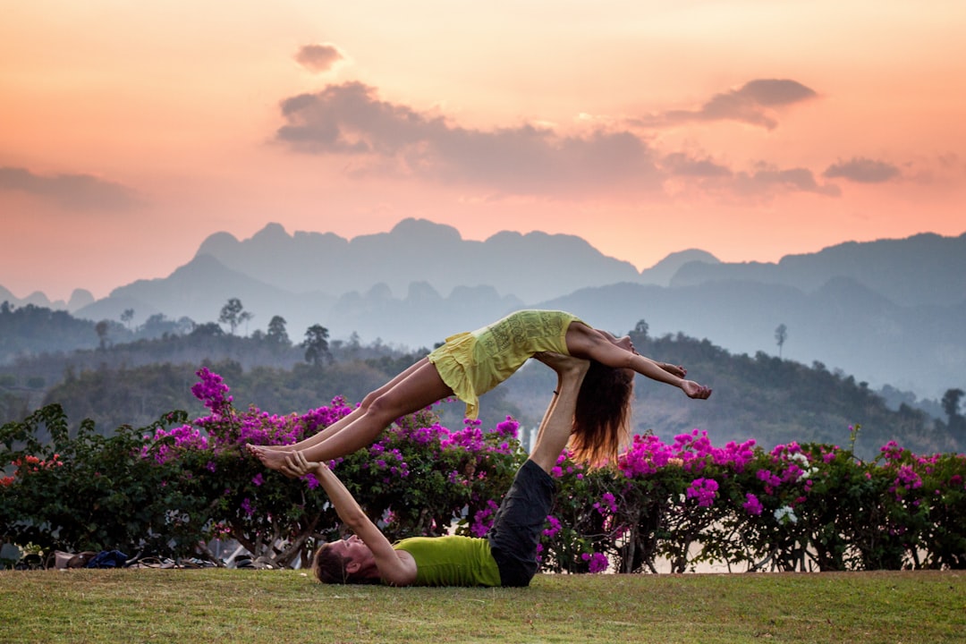 man and woman doing couple yoga, Acro yoga at Khao Sok sunset