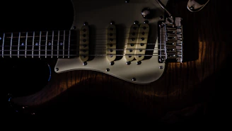 A finished custom guitar glowing under studio lights, emphasizing the blend of modern design and traditional craftsmanship.