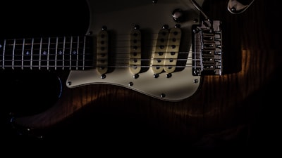 brown and white electric guitar instrument teams background