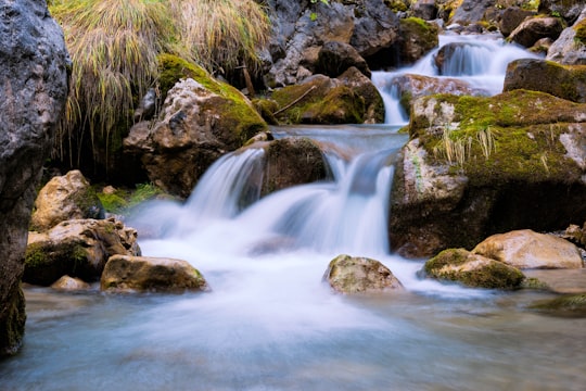 time lapse photography of multi-step waterfalls in Pozza di Fassa Italy