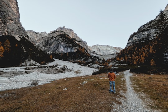 man facing mountain range in Parco naturale di Fanes-Sennes-Braies Italy