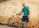 man holding orange beach cruiser