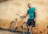 man holding orange beach cruiser