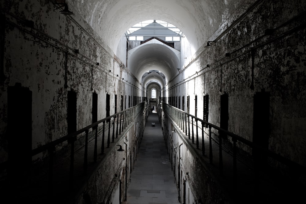 grayscale photo of hallway inside building