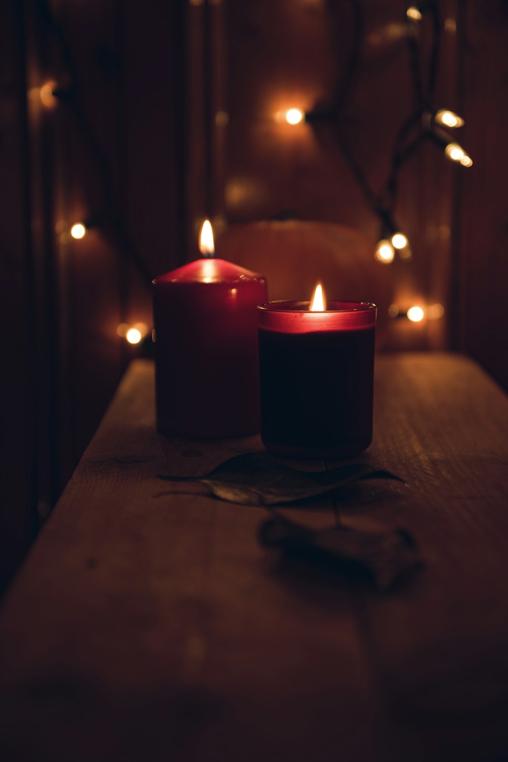 macro shot photography of two votive candles