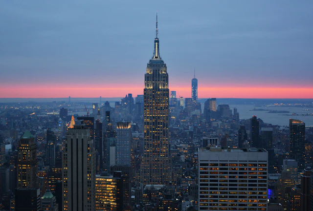 The classic dusk view from Top of the Rock looking south over Midtown to the illuminated Empire State Building.