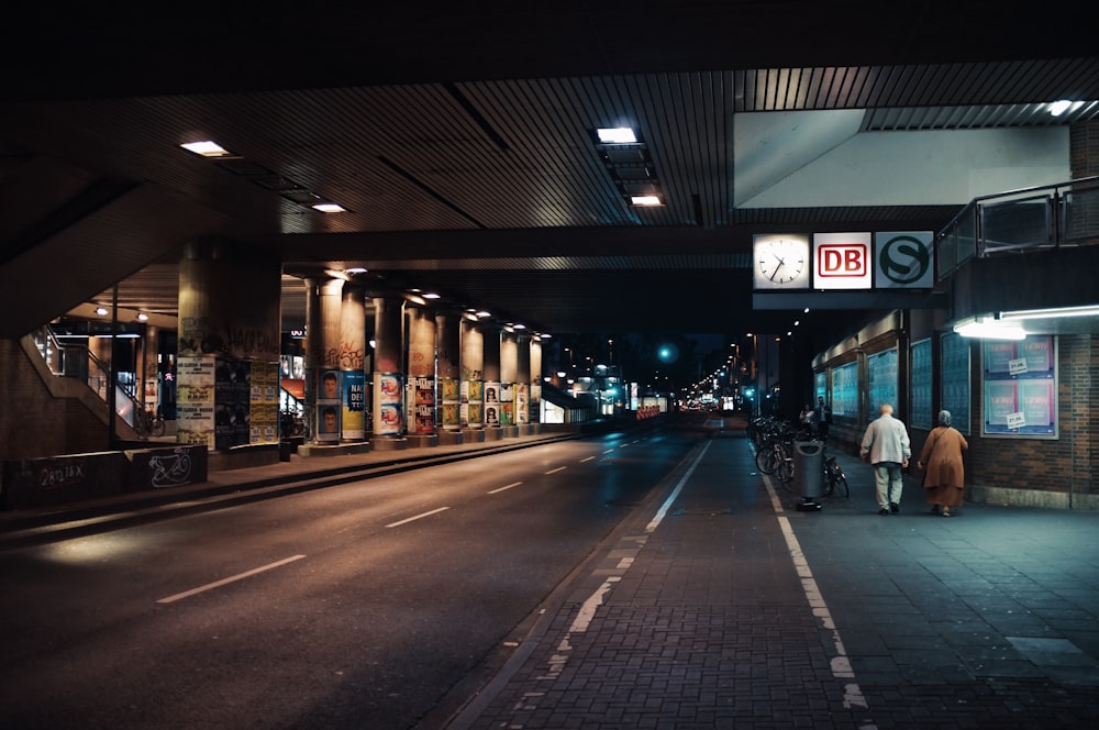 two person walking on side street