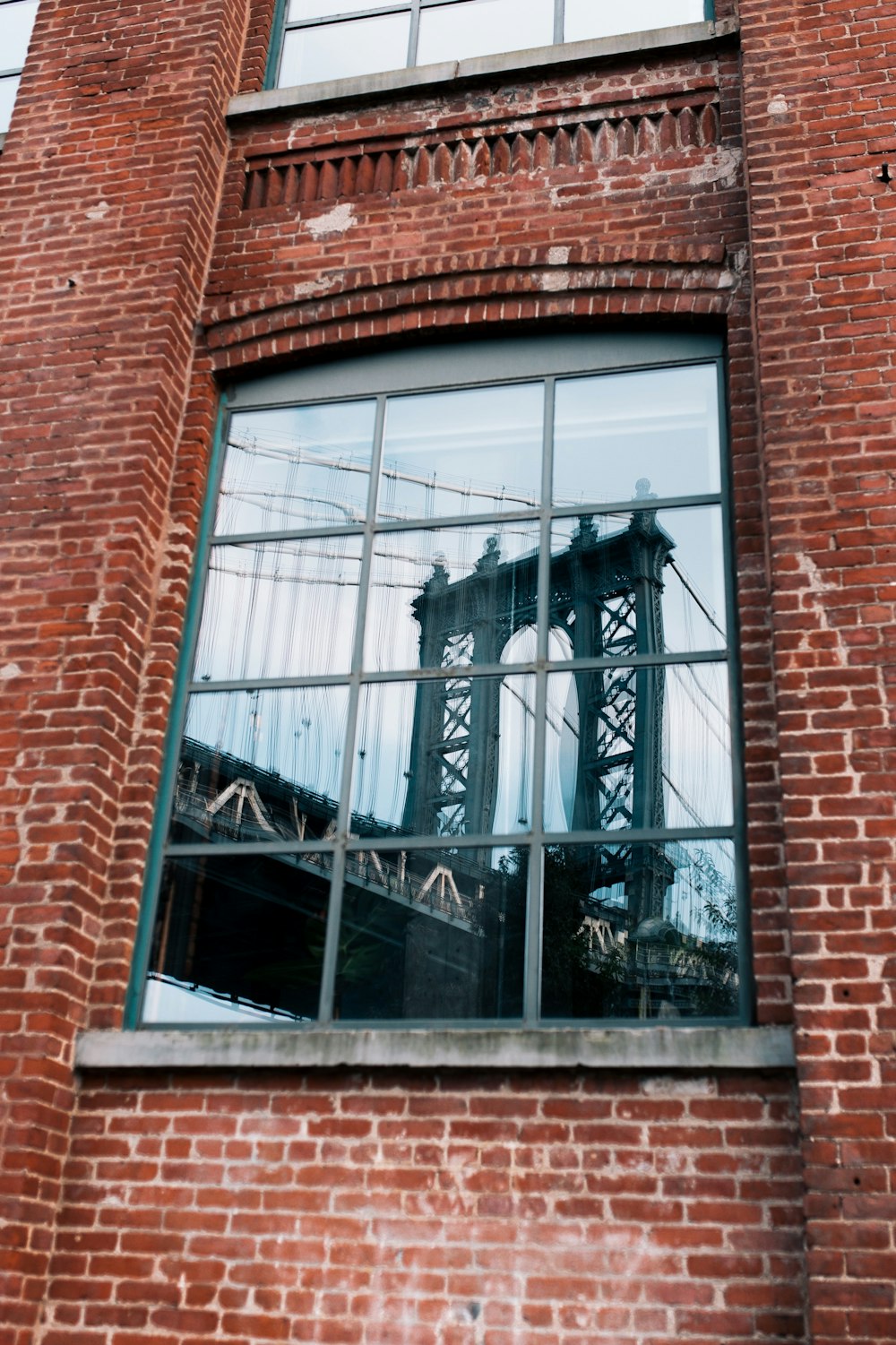 a reflection of a bridge in a window