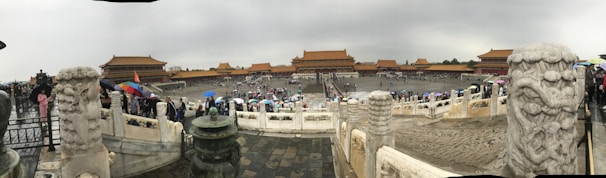 A panoramic view of a prestigious Chinese medical university campus with modern buildings and students walking.