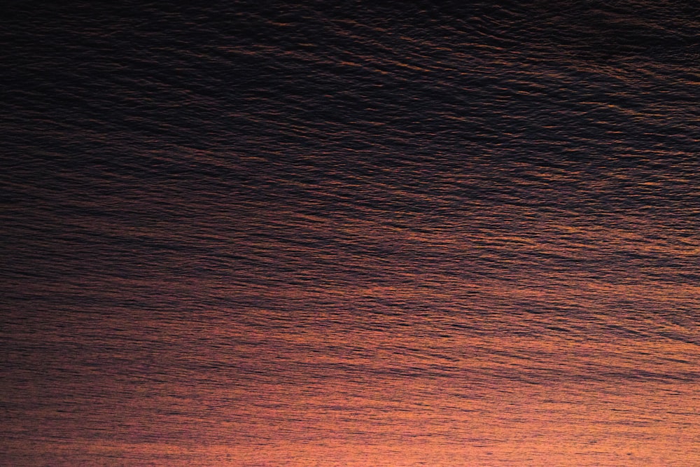 a person riding a surfboard on top of a wave