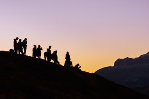 silhouette of group of people on hill