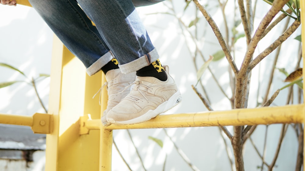 person wearing beige Puma Trinomic sneakers