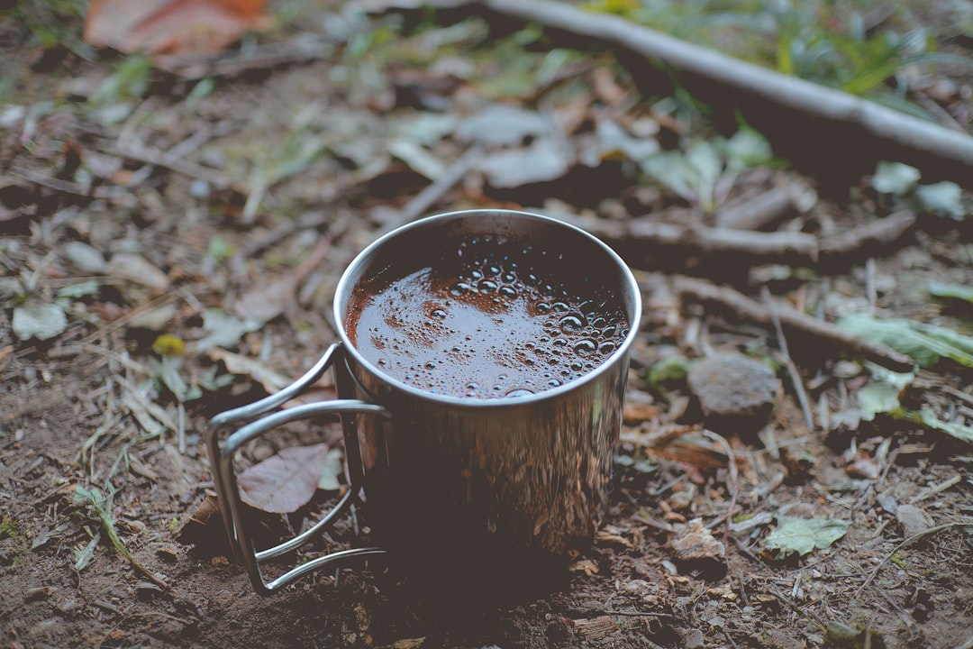 silver coffee mug on ground