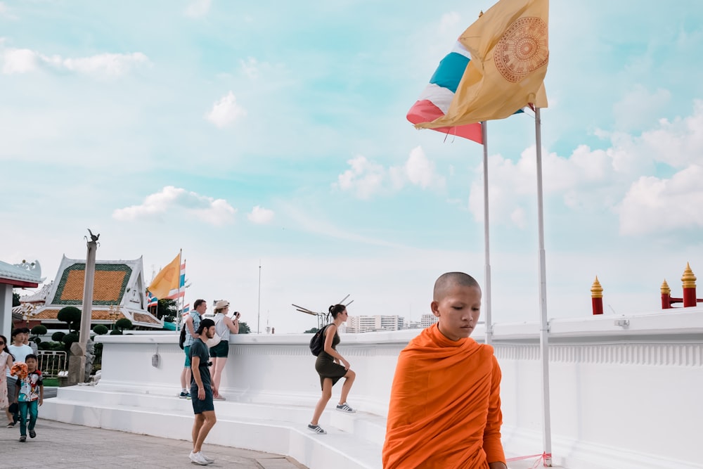 monk standing near white wall