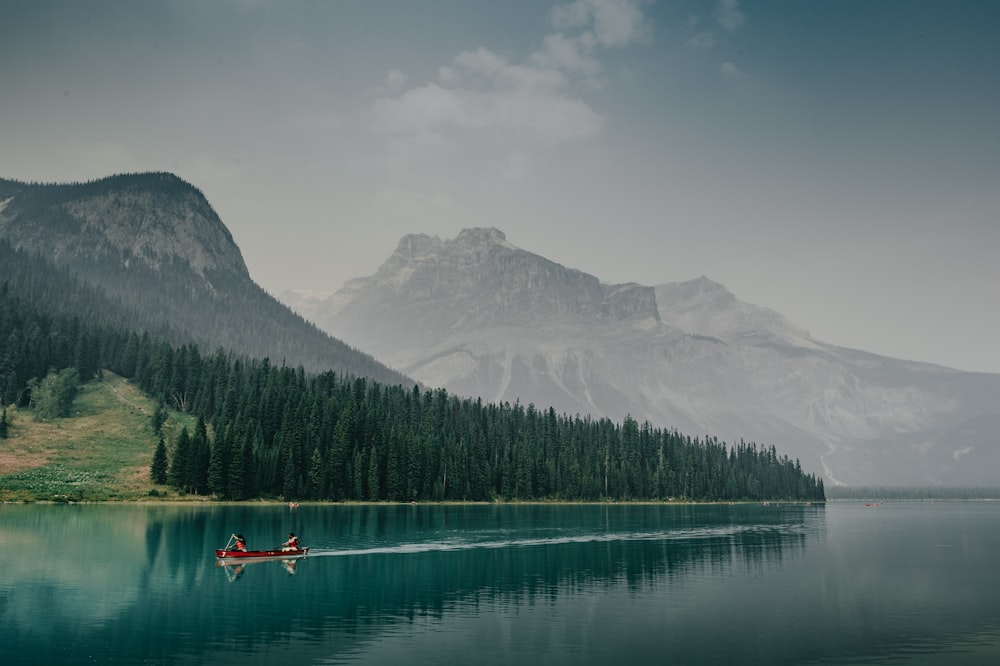 person riding on red boat