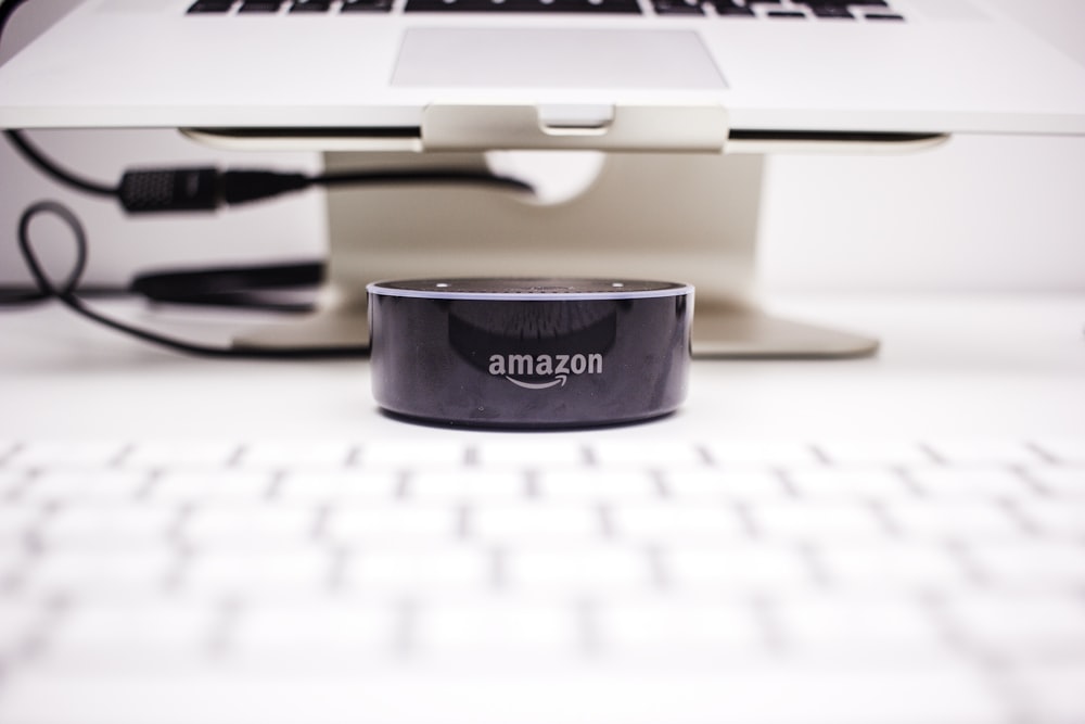 Amazon Echo Dot near laptop on stand