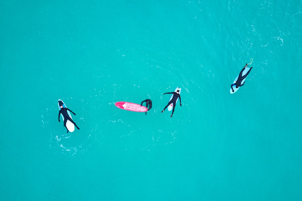 four person on body of water