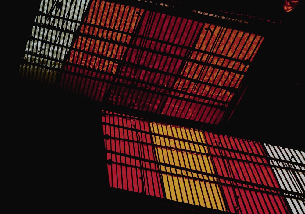 a close up of a metal structure with red and yellow squares