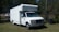 A satisfied client with a box truck in the background.