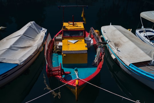 piled empty boat on body of water in Nea Artaki Greece