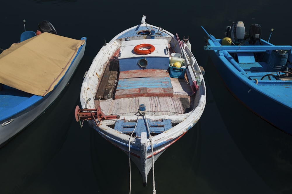 white and blue wooden boat