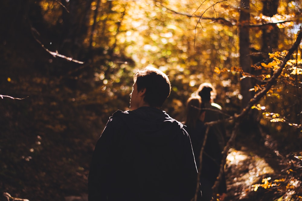 man standing between trees