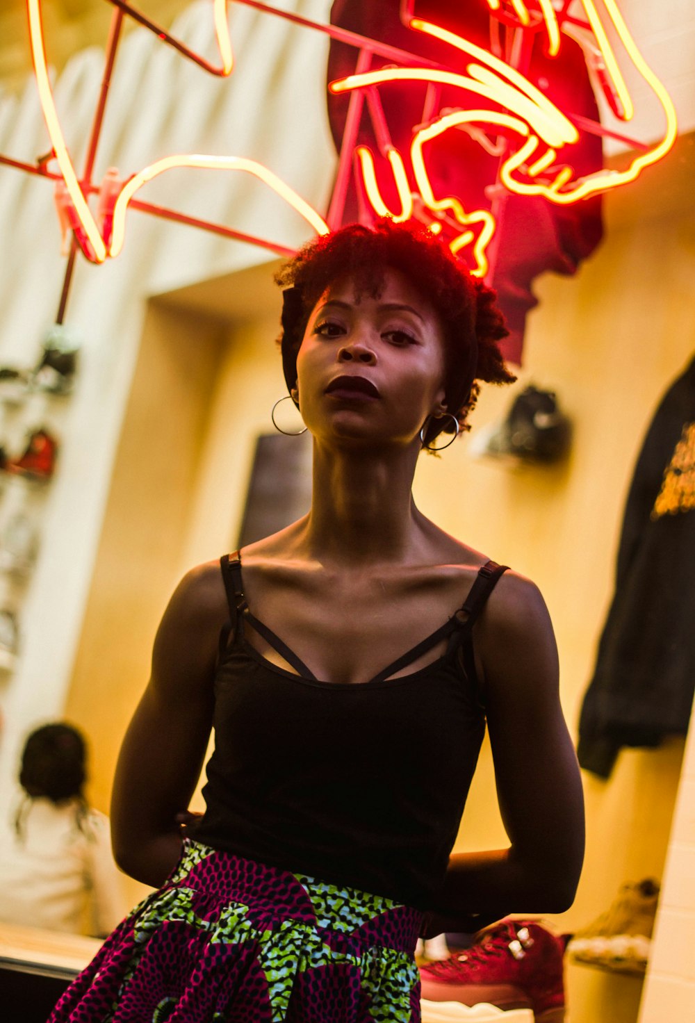 woman standing near neon light signage