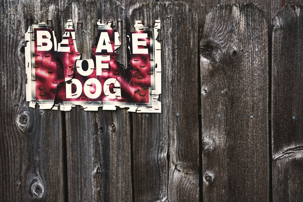 beware of dog sign on wood fence