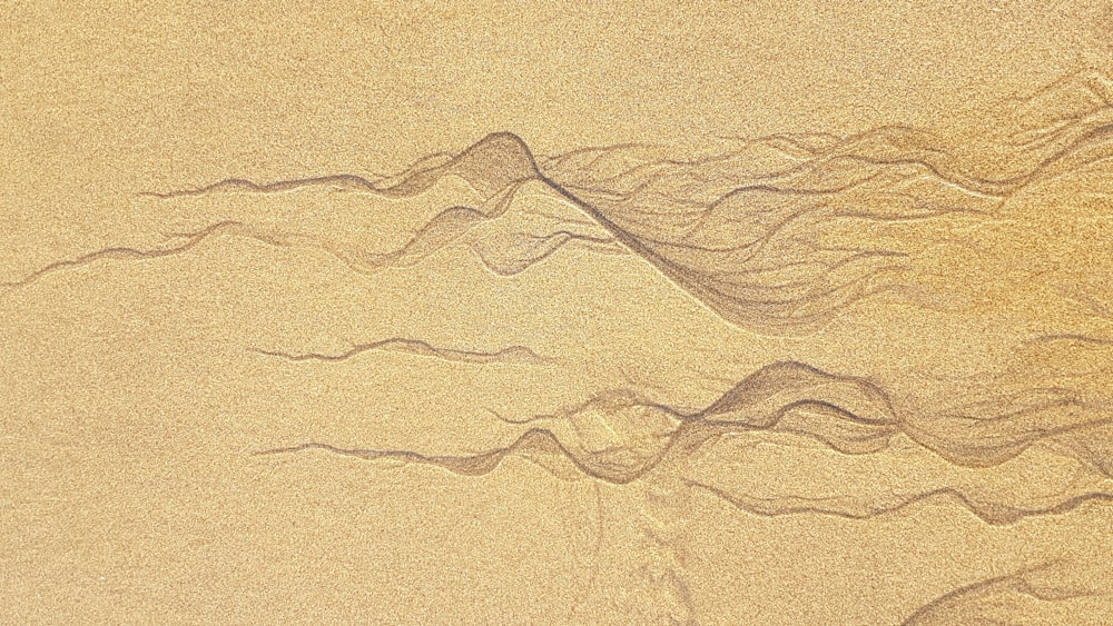 a wave is making its way across the sand
