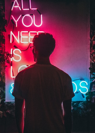 man standing beside signage