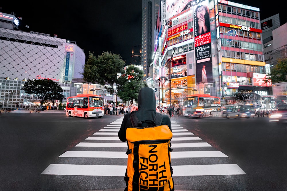 person wearing backpack standing in front of New York Time Square