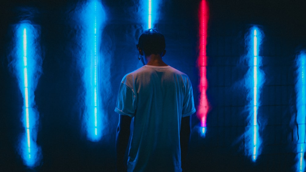man standing near blue LED strips