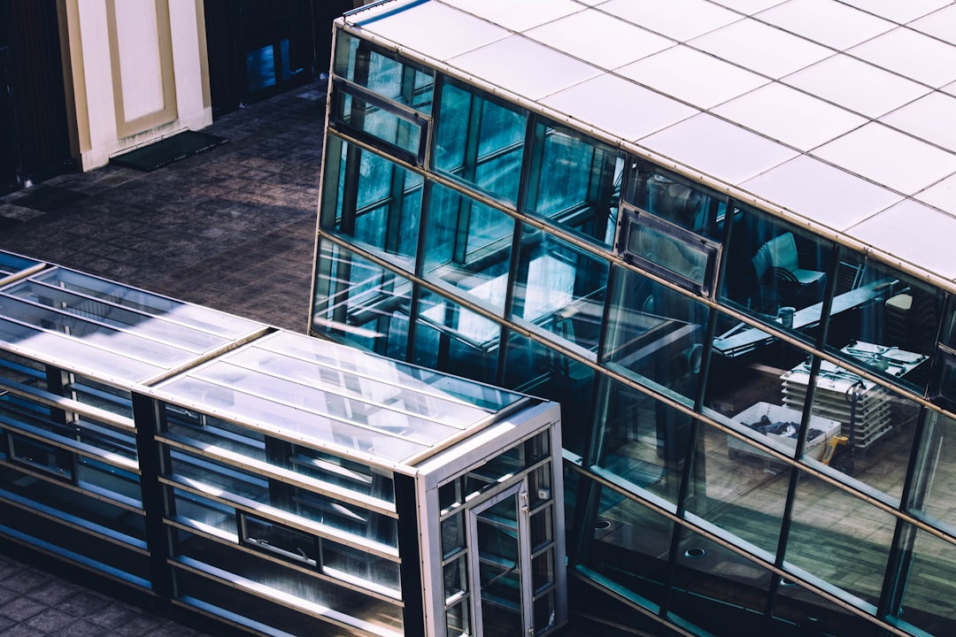 glass building beside glass train