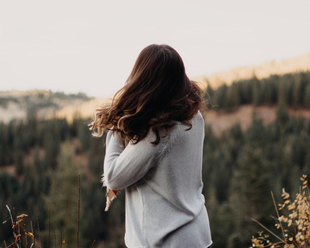 woman standing looking on trees