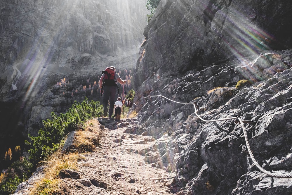 man walking on mountain side