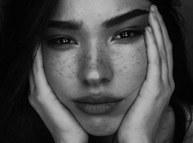 grayscale photography of woman with two hands on her face onlyfans