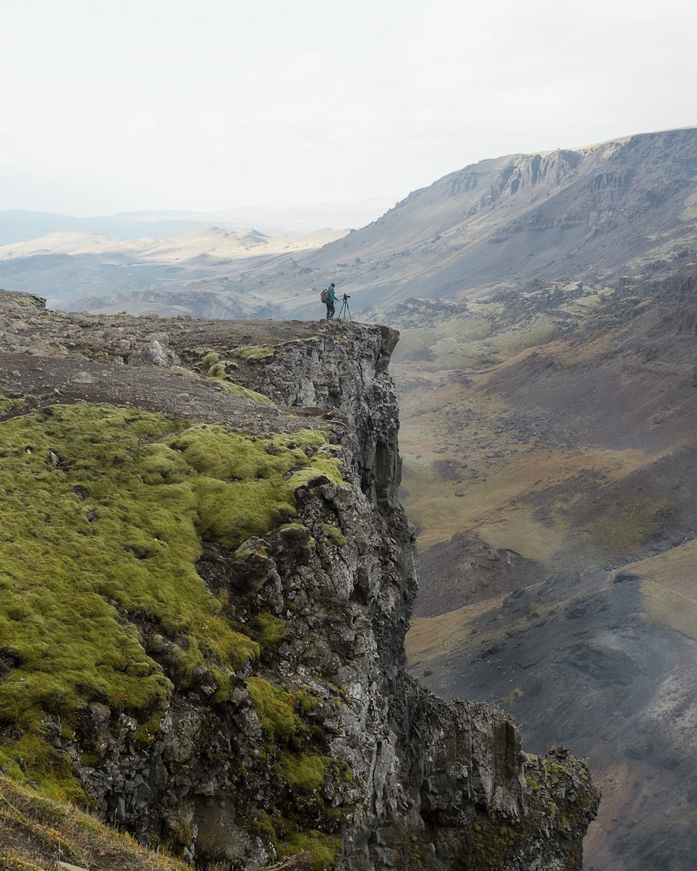 person standing beside cliff during daytime