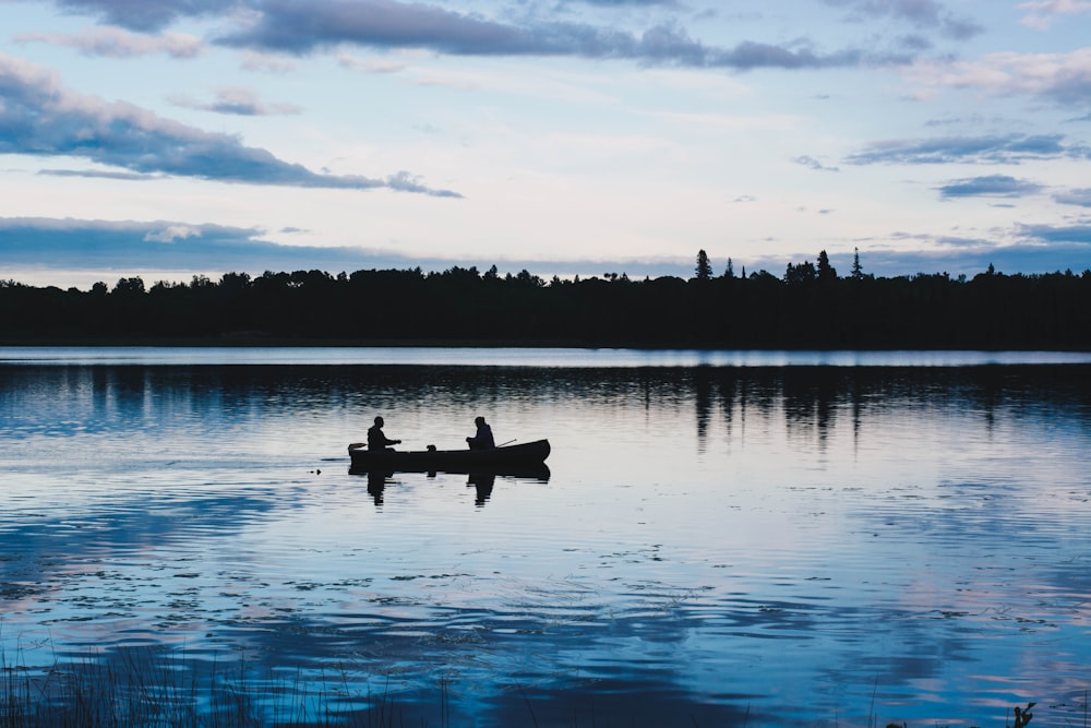 two men on kayak fishing on lake
