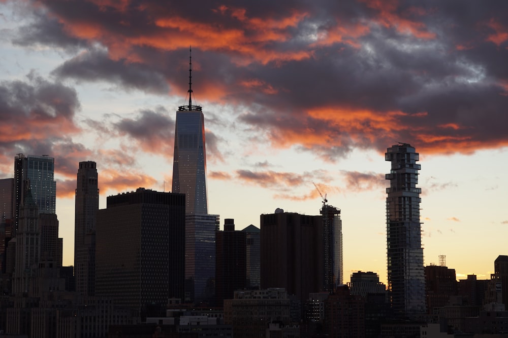 a sunset view of a city with tall buildings